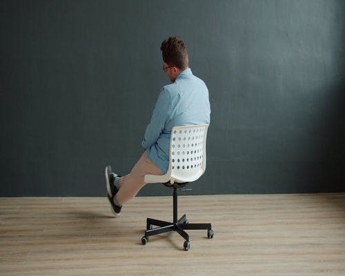Person adjusting office chair for better posture