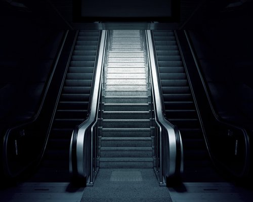Commuter choosing stairs over escalator in a station